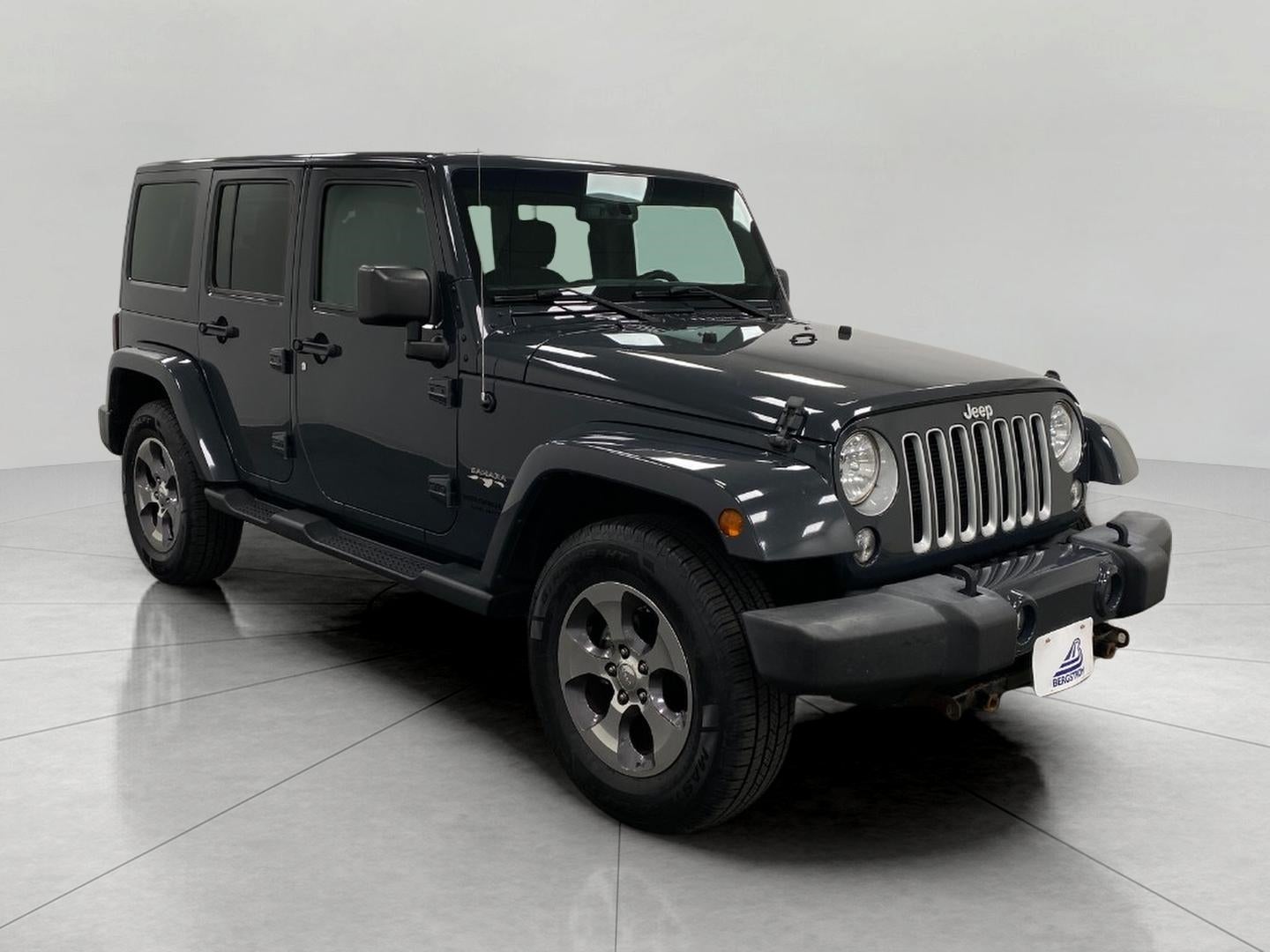 2016 Jeep Wrangler Unlimited 4WD 4dr Sahara in Rhino Clearcoat — front three-quarter view