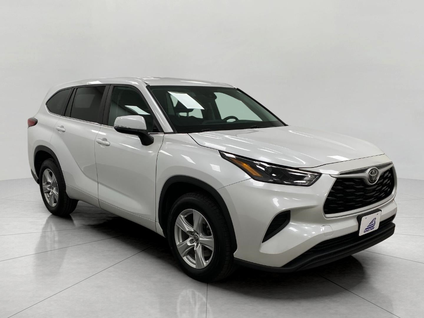 2023 Toyota Highlander L FWD in Wind Chill Pearl — front three-quarter view