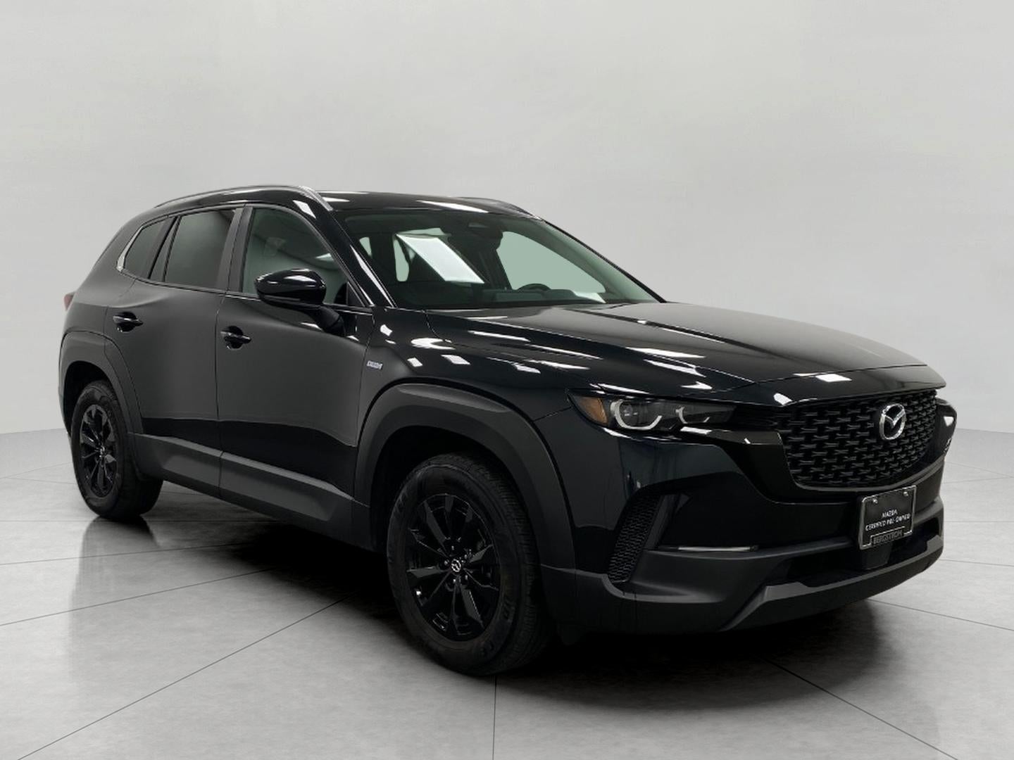 2025 Mazda Mazda CX-50 Hybrid Preferred Package AWD in Jet Black Mica — front three-quarter view
