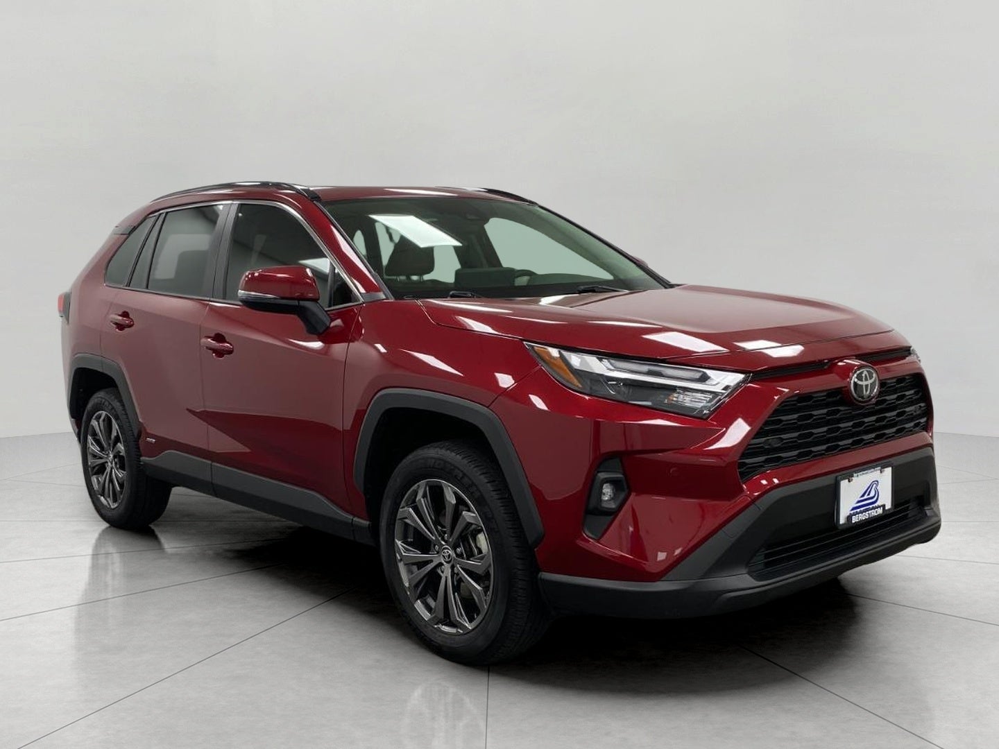 2025 Toyota RAV4 Hybrid XLE Premium AWD in Ruby Flare Pearl — front three-quarter view